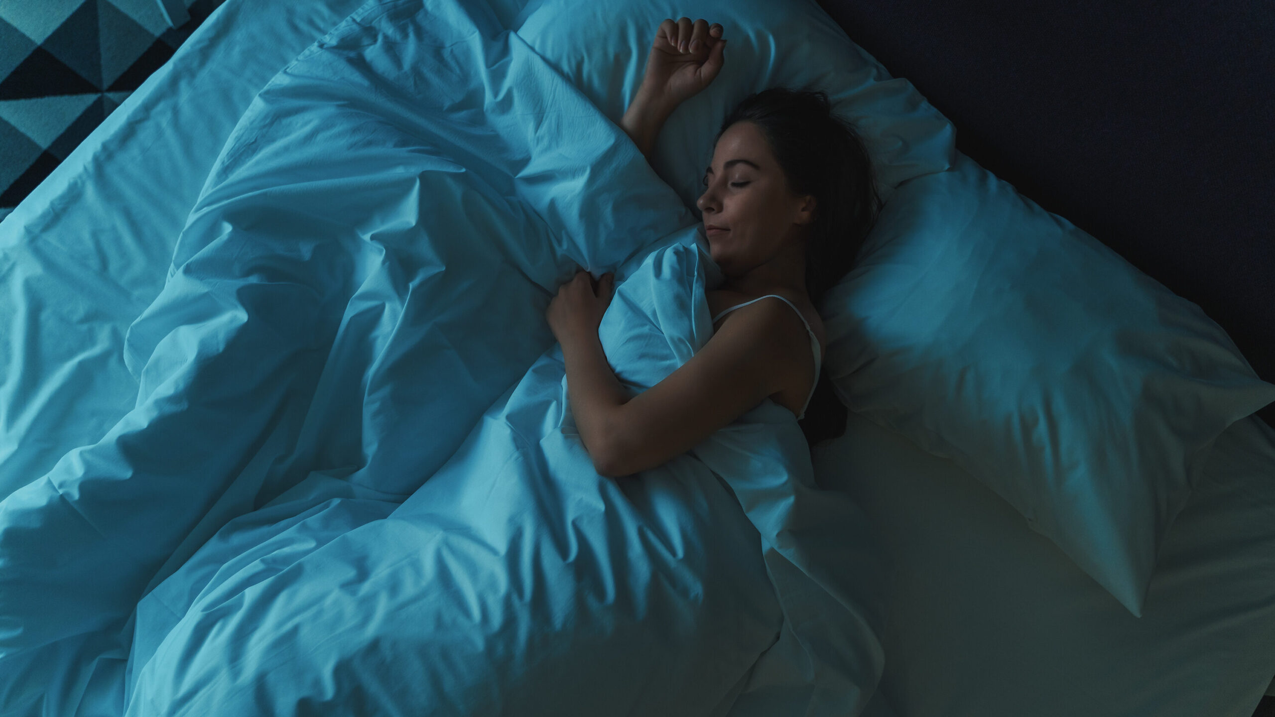 Woman sleeping in bed.