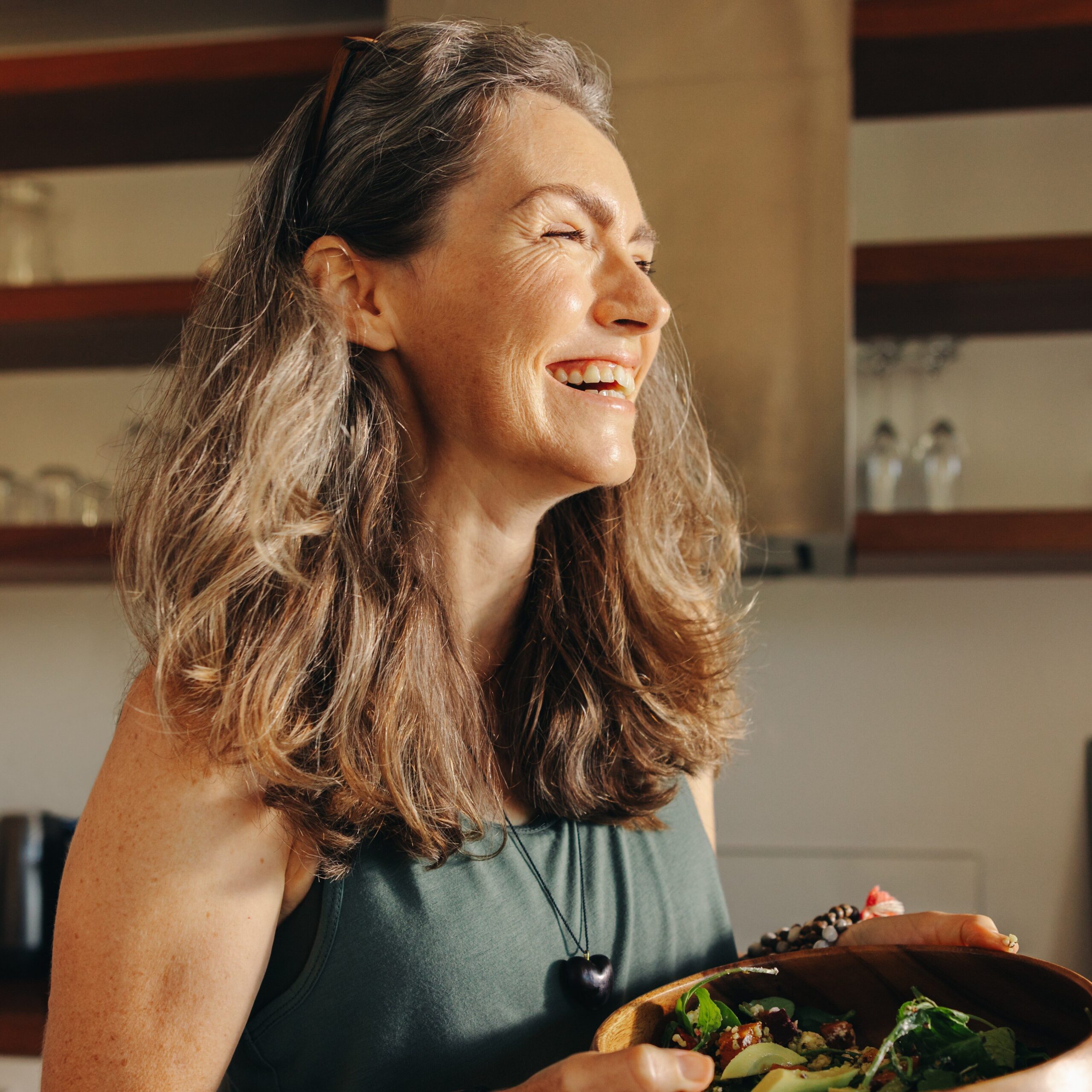 A smiling woman eating healthy.