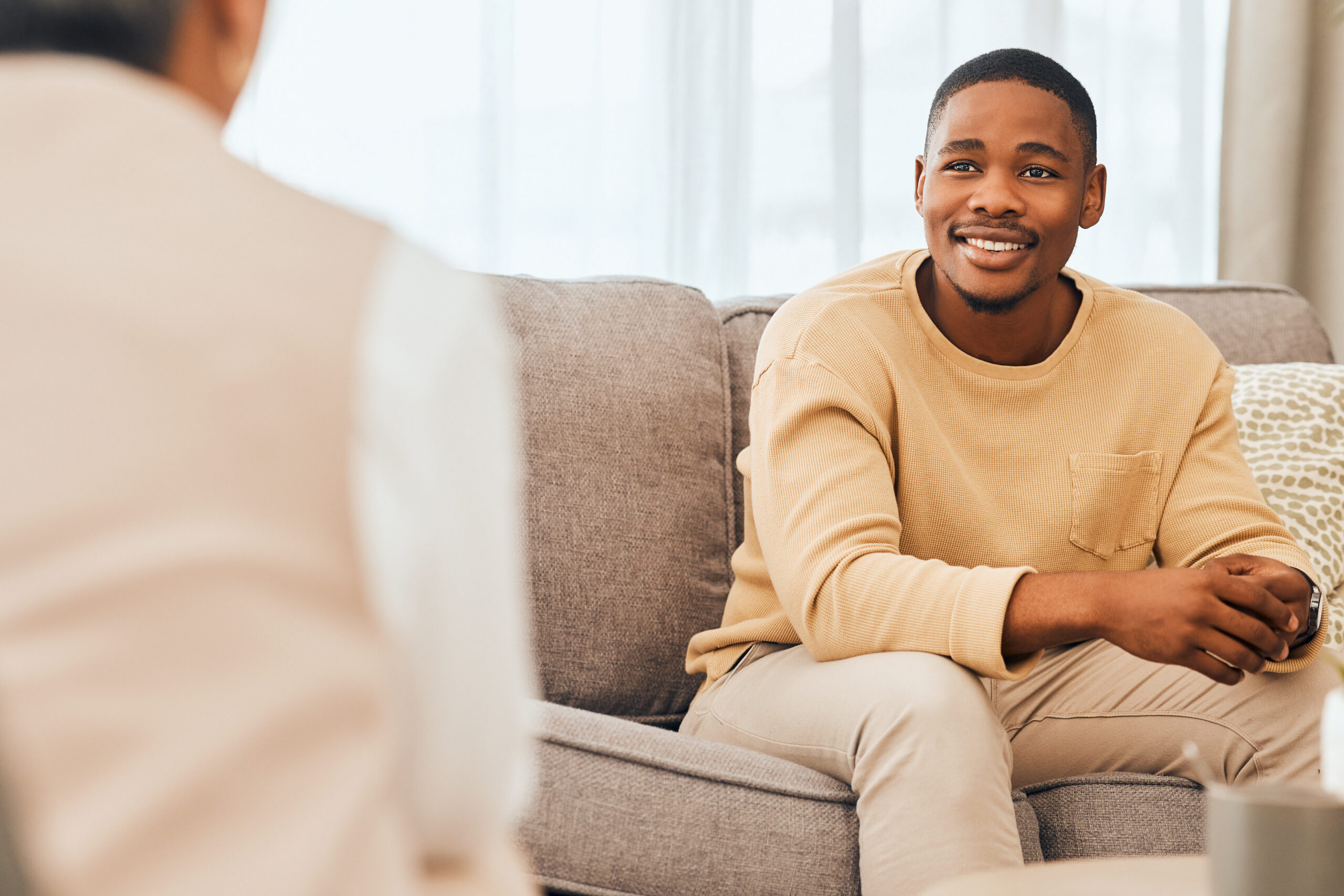 A male client looking hopeful in therapy.